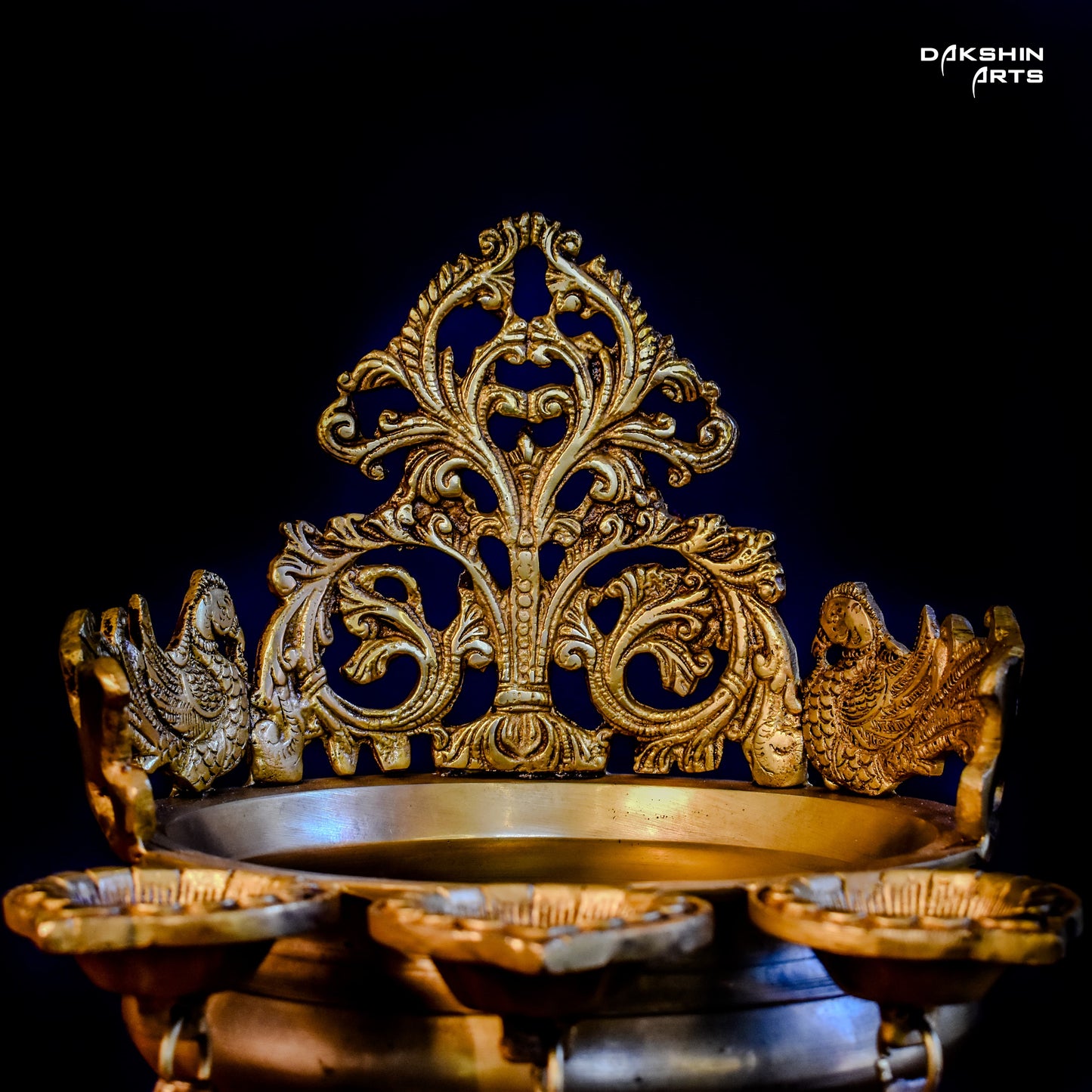 Ornate golden urli with oil lamps with intricate floral and peacock designs - Dakshin Arts