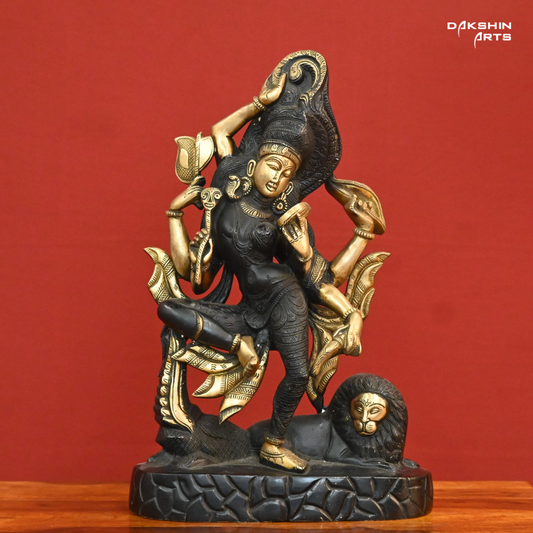 A black gold colored statue of Ardhanareshwar adorned with detailed patterns, with a lion at the base- Dakshin Arts