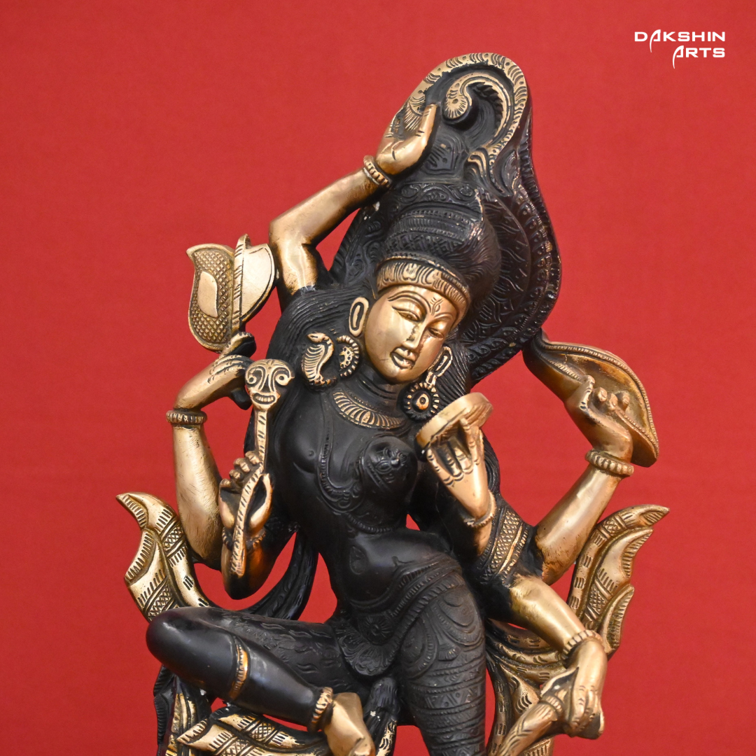 A black gold colored statue of Ardhanareshwar adorned with detailed patterns, with a lion at the base- Dakshin Arts