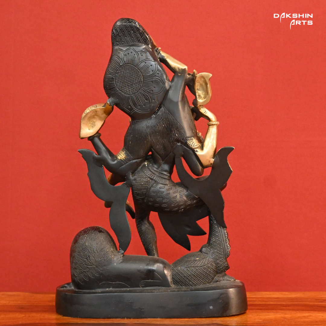 A black gold colored statue of Ardhanareshwar adorned with detailed patterns, with a lion at the base- Dakshin Arts