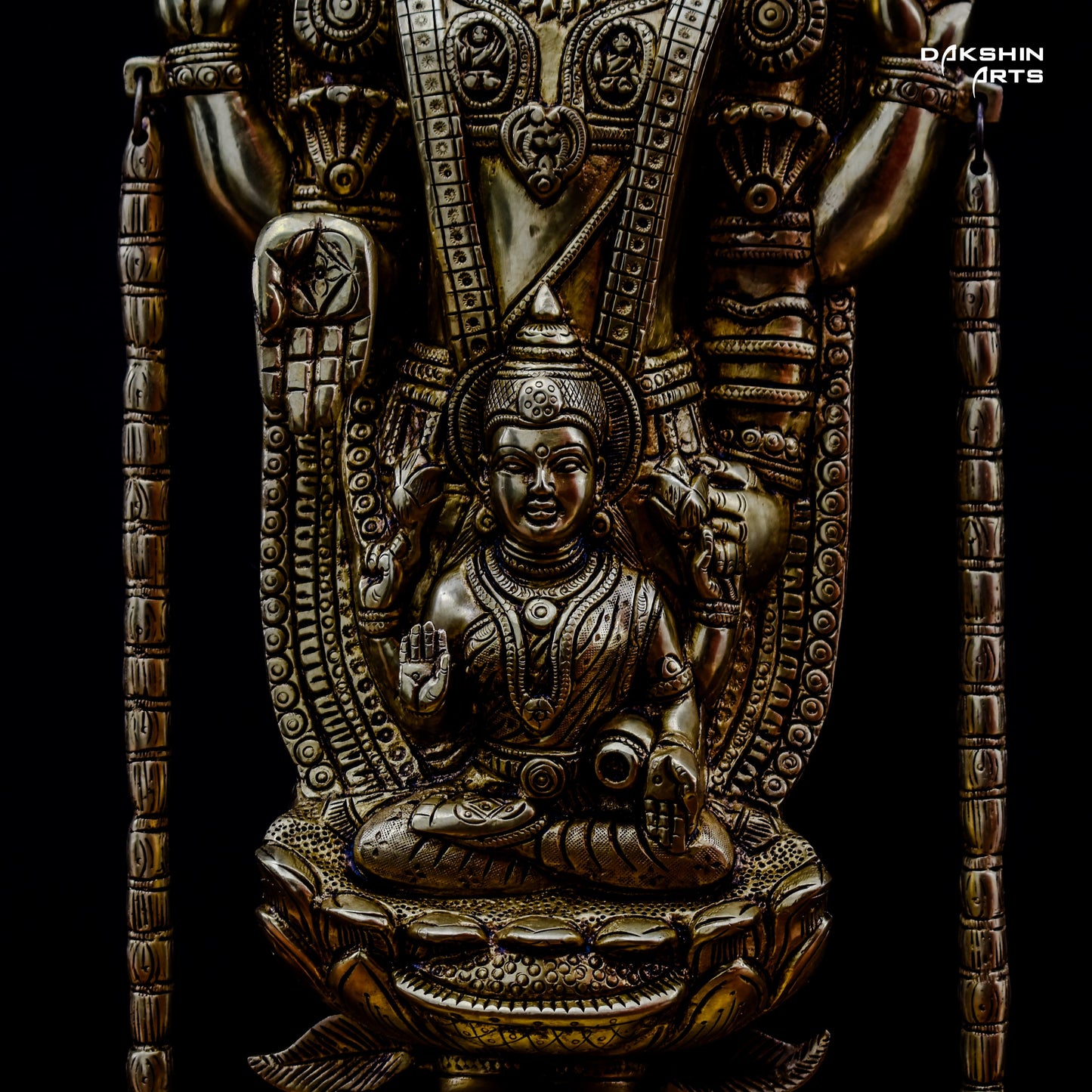 Closeup of the Padmavati in the brass Balaji Padmavati idol against a black background - Dakshin Arts