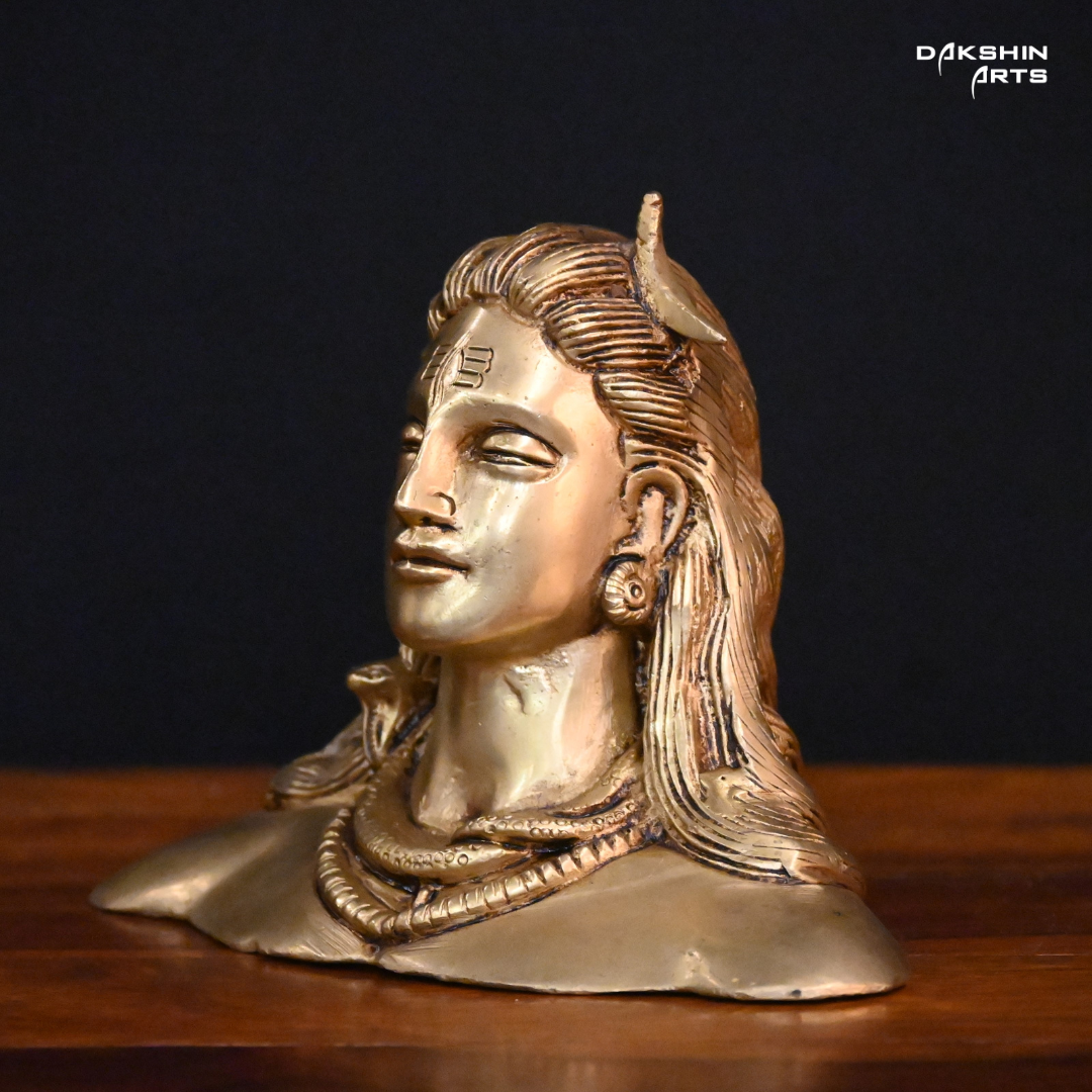 Side pose of Brass adiyogi with closed eyes, featuring a crescent on the head, against a dark background.