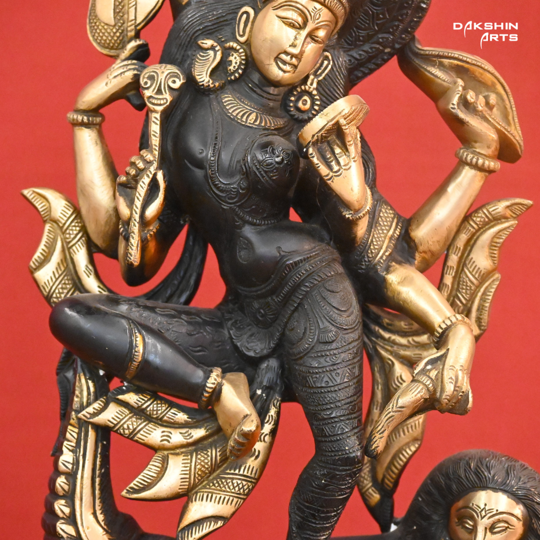 A black gold colored statue of Ardhanareshwar adorned with detailed patterns, with a lion at the base- Dakshin Arts
