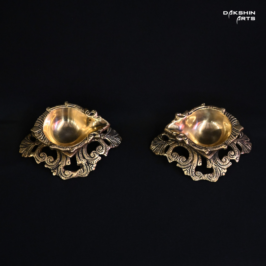 Two ornate brass diyas, intricately designed, showcasing traditional craftsmanship and elegance- Dakshin Arts